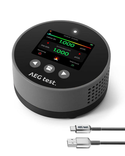 Compact AEG test radon detector with digital display, audible and visual alarms, and USB charging cable for accurate room-to-room radon monitoring